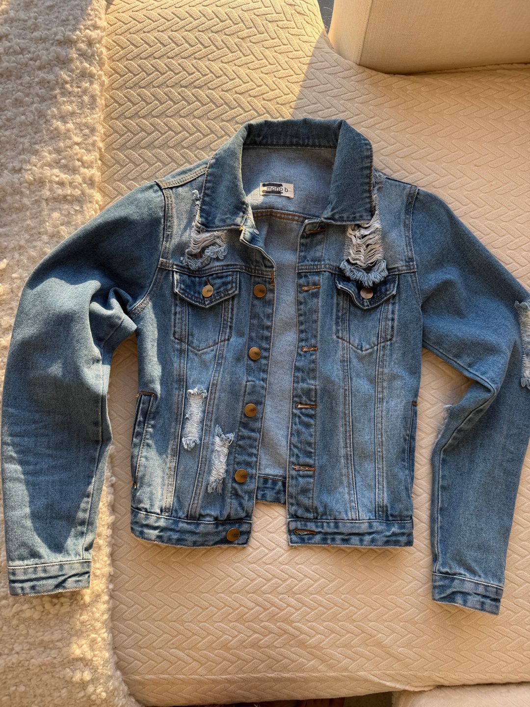 Distressed blue denim jacket