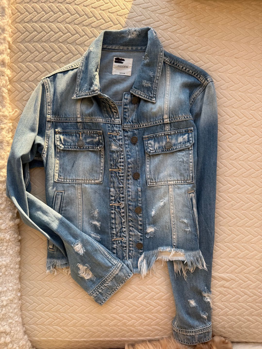 Distressed blue denim jacket