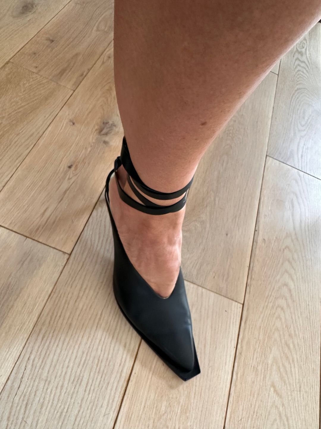 Black leather pumps with ankle ties