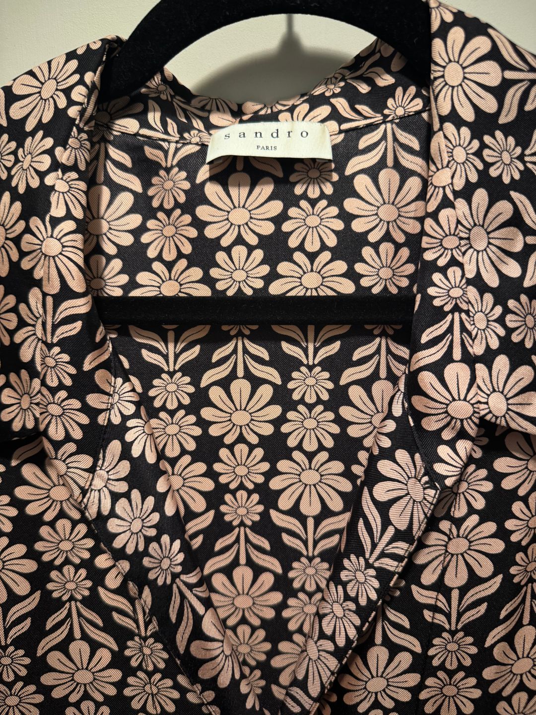 Sandro Drop waist silk mini dress with pink daisies against dark navy. Long sleeves, gold button