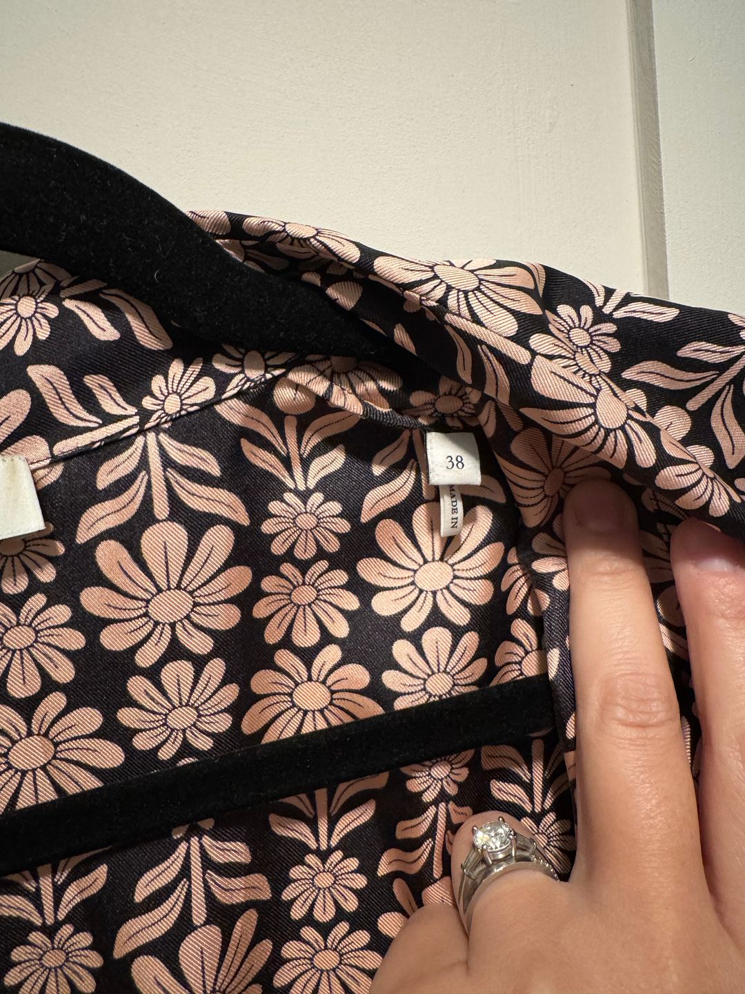 Sandro Drop waist silk mini dress with pink daisies against dark navy. Long sleeves, gold button