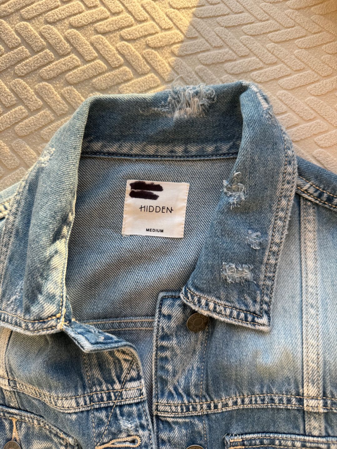 Distressed blue denim jacket