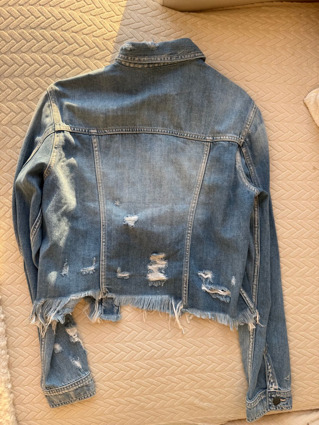 Distressed blue denim jacket