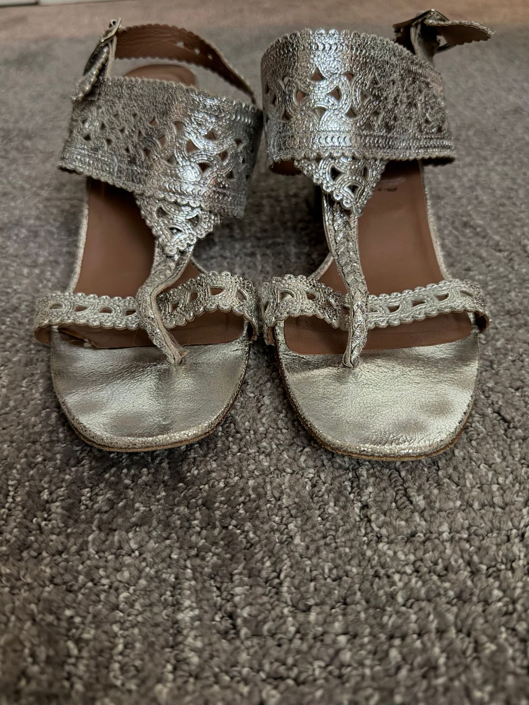 Silver sandals with intricate design