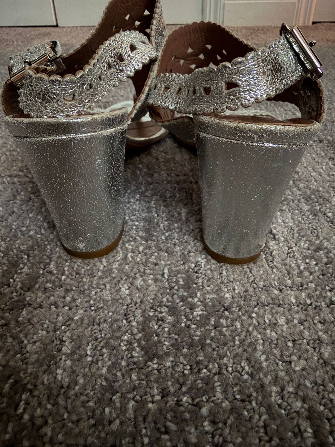 Silver sandals with intricate design