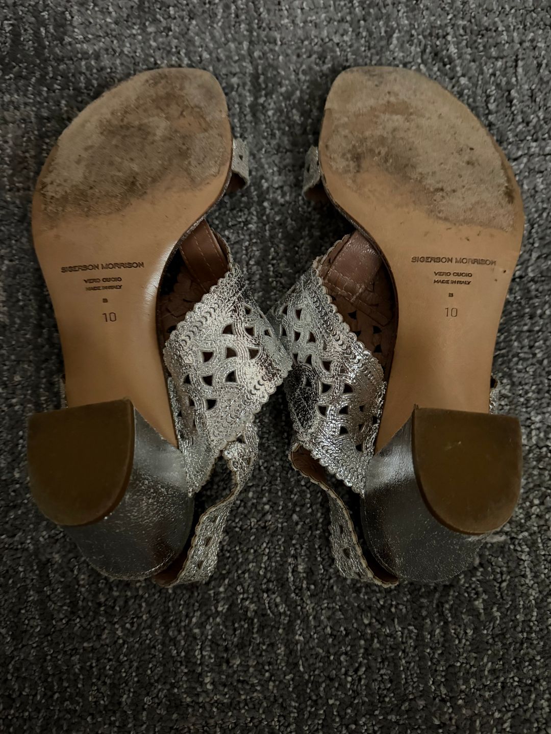 Silver sandals with intricate design