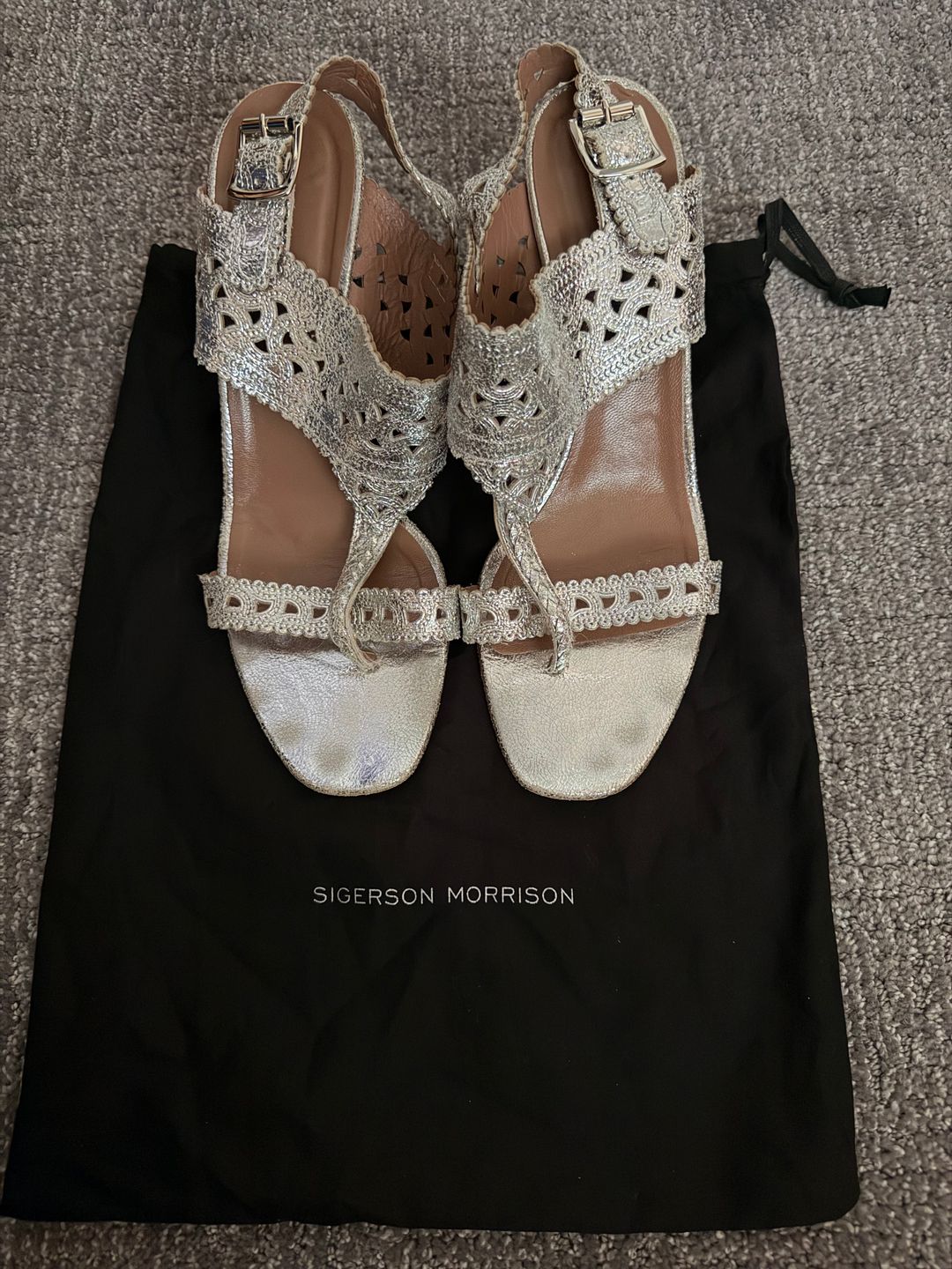 Silver sandals with intricate design