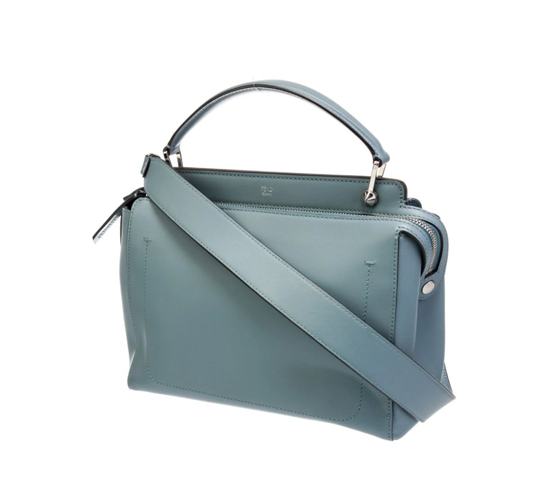 Fendi Fendi Leather Dotcom Medium top handle bag from the 2016 Collection by Karl Lagerfeld. Blue leather with silver-tone hardware. Flat handle and single shoulder strap. Suede lining and dual interior pockets. Zip closure at top. Protective feet at base and INCLUDES DUST BAG. 